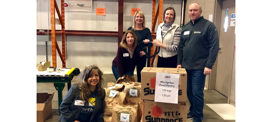 Northfield Savings Bank employees Nubia Fuller, Maryellen LaPerle, Wendy Kellett, Ava Whitcomb, Mark Mast (pictured left to right) helped pack grocery bags full of healthy food items to donate to local organizations that distribute to our neighbors in need.